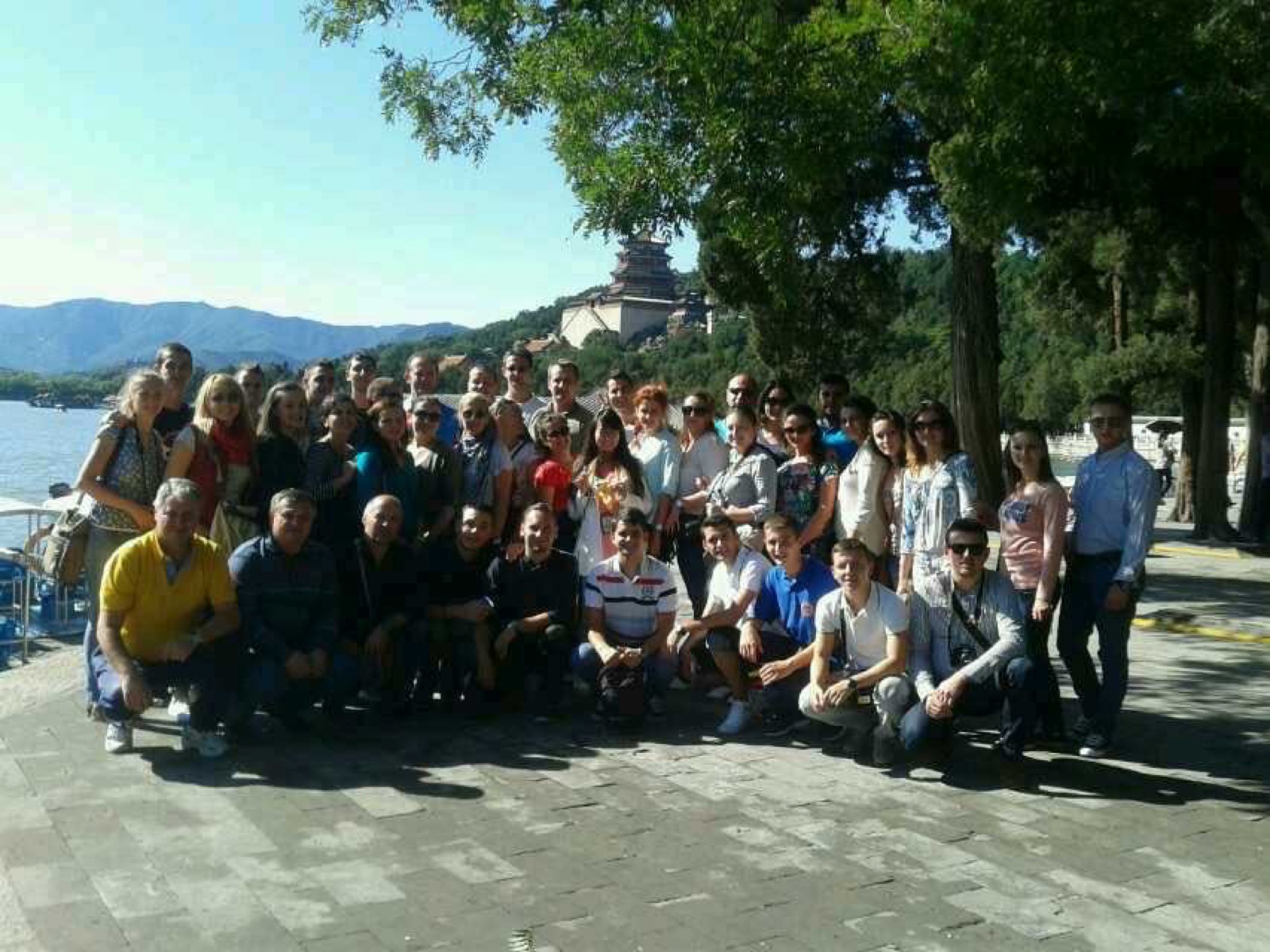 Large private group traveling in Beijing with lake and mountain view
