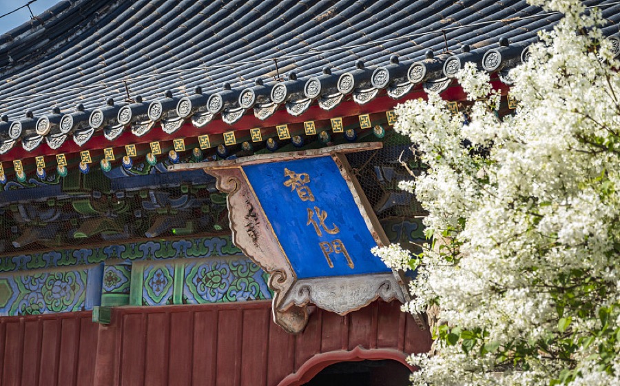 Zhihua Temple gate with grey tiled roof and blue plaque in Beijing